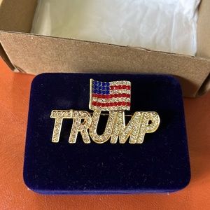 I Love Trump American Flag crystal adorned pin. 2”wide by 1 1/4” length.
